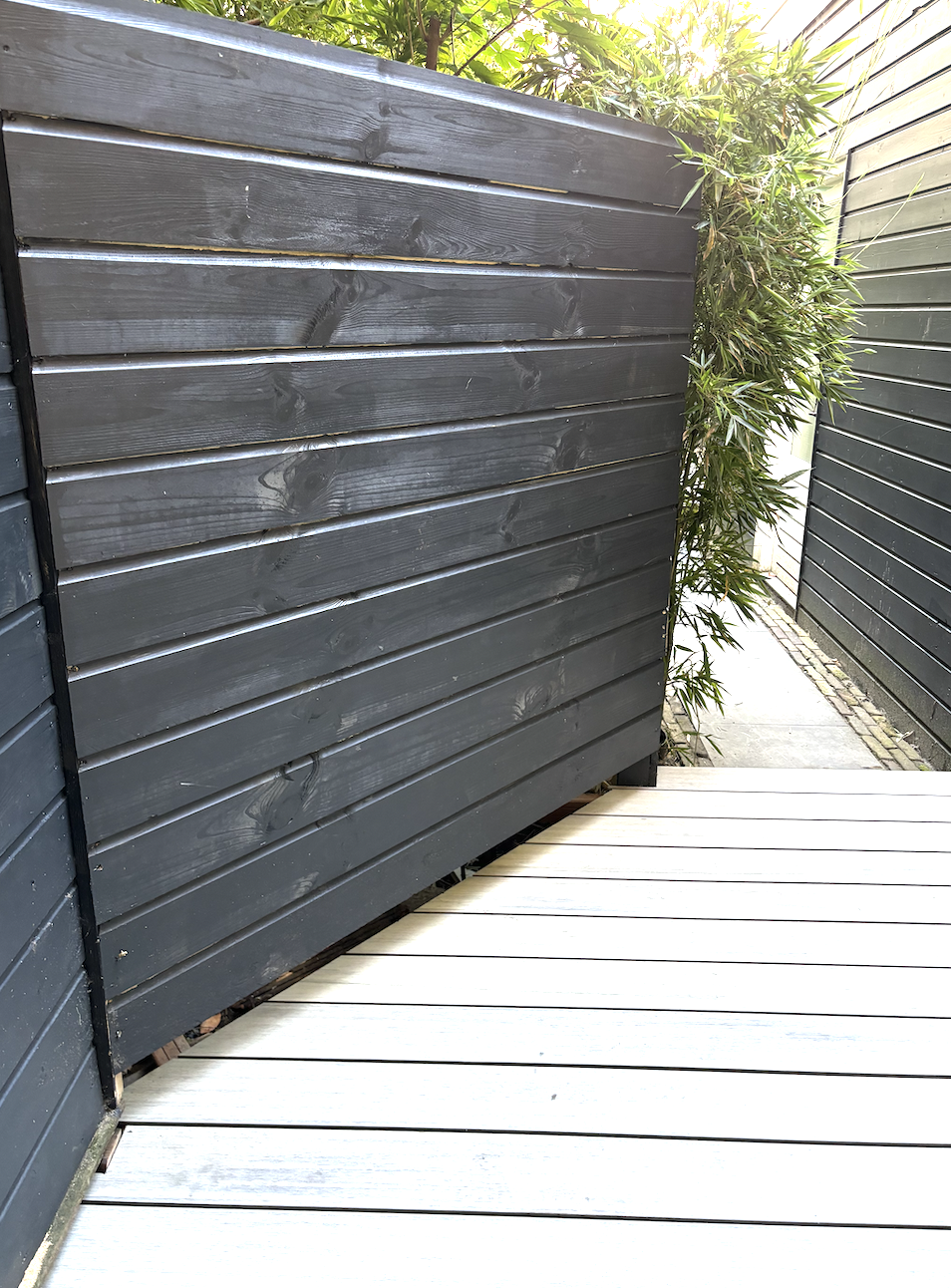 Dark painted garden fence and terrace